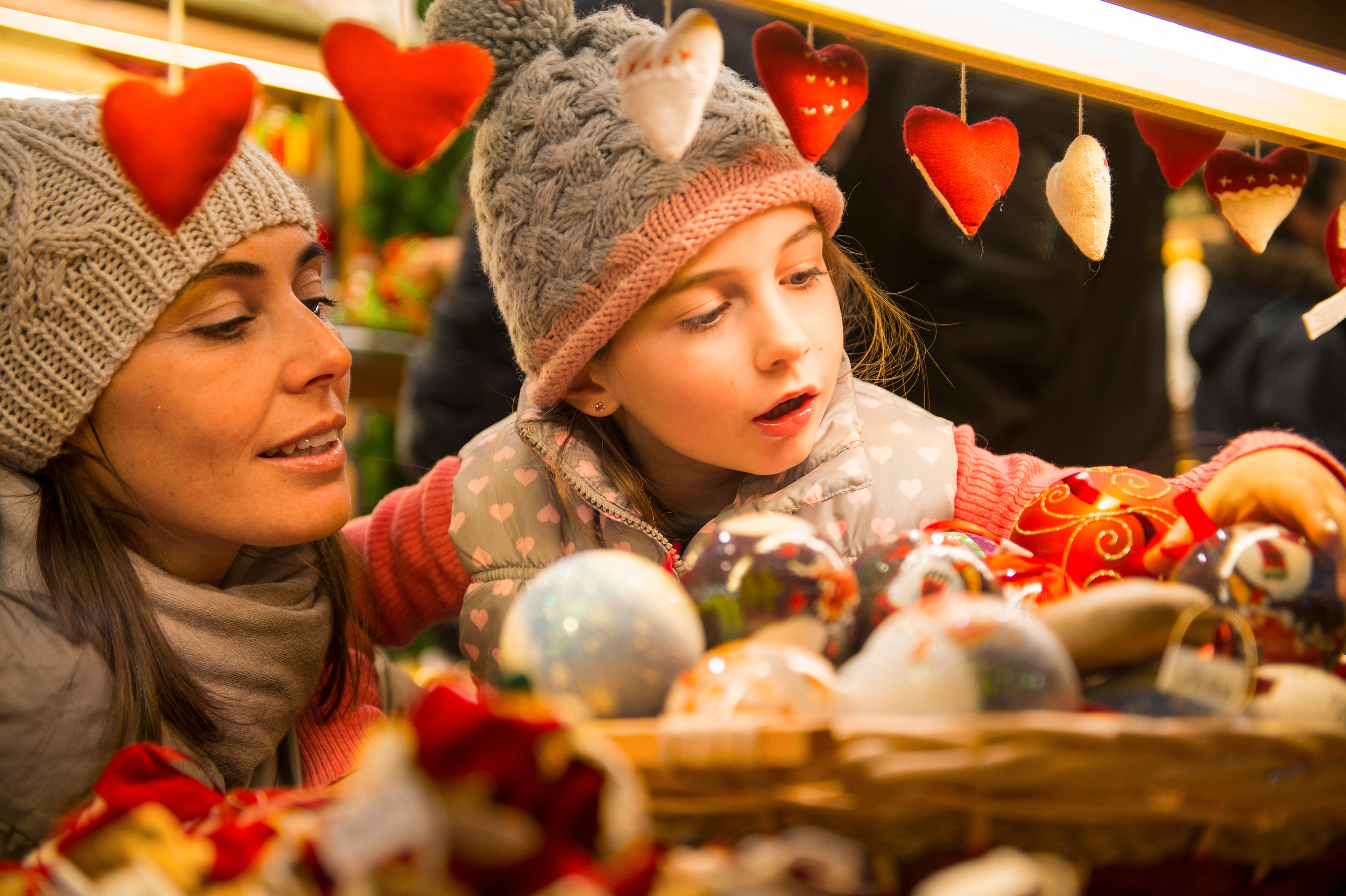 a woman and child looking at ornaments