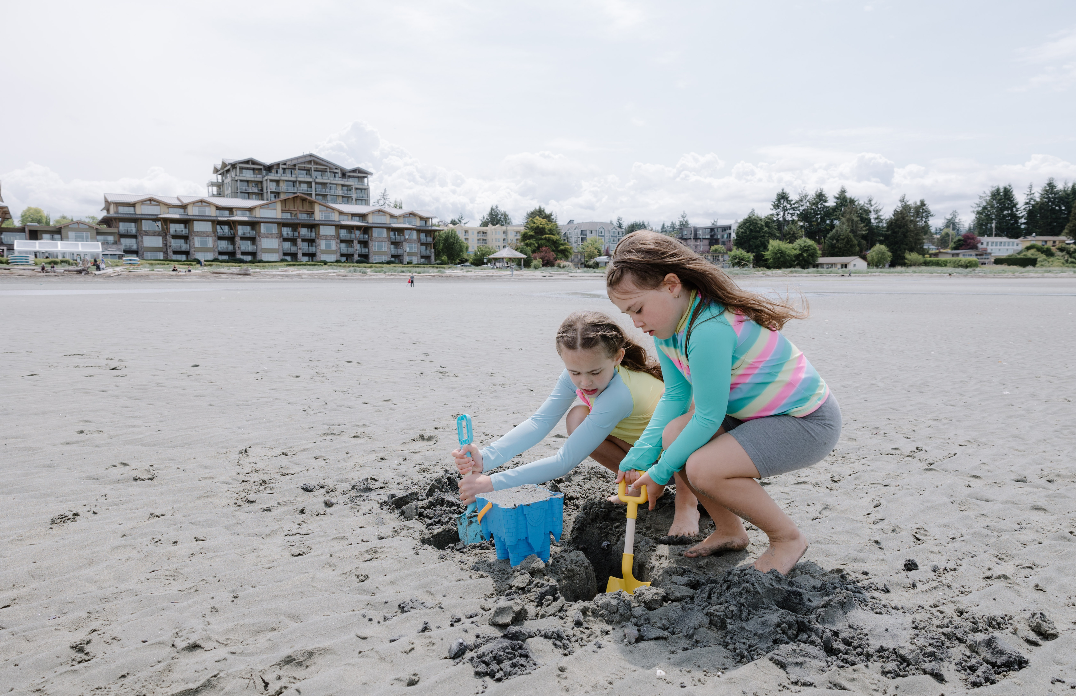 two girls playing in the sand