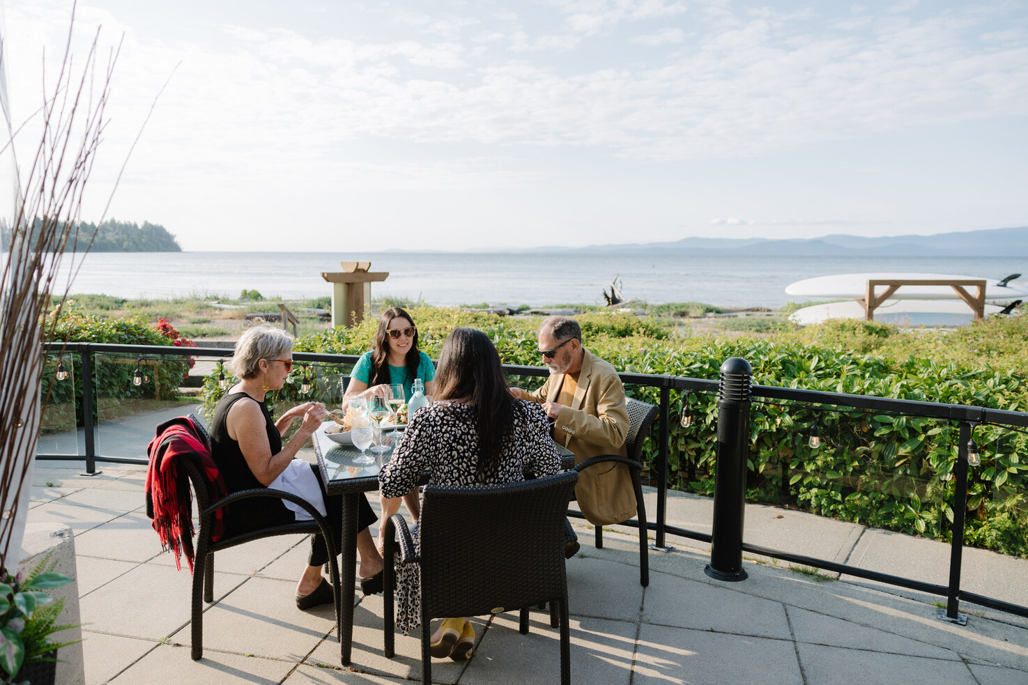 a group of people sitting at a table outside