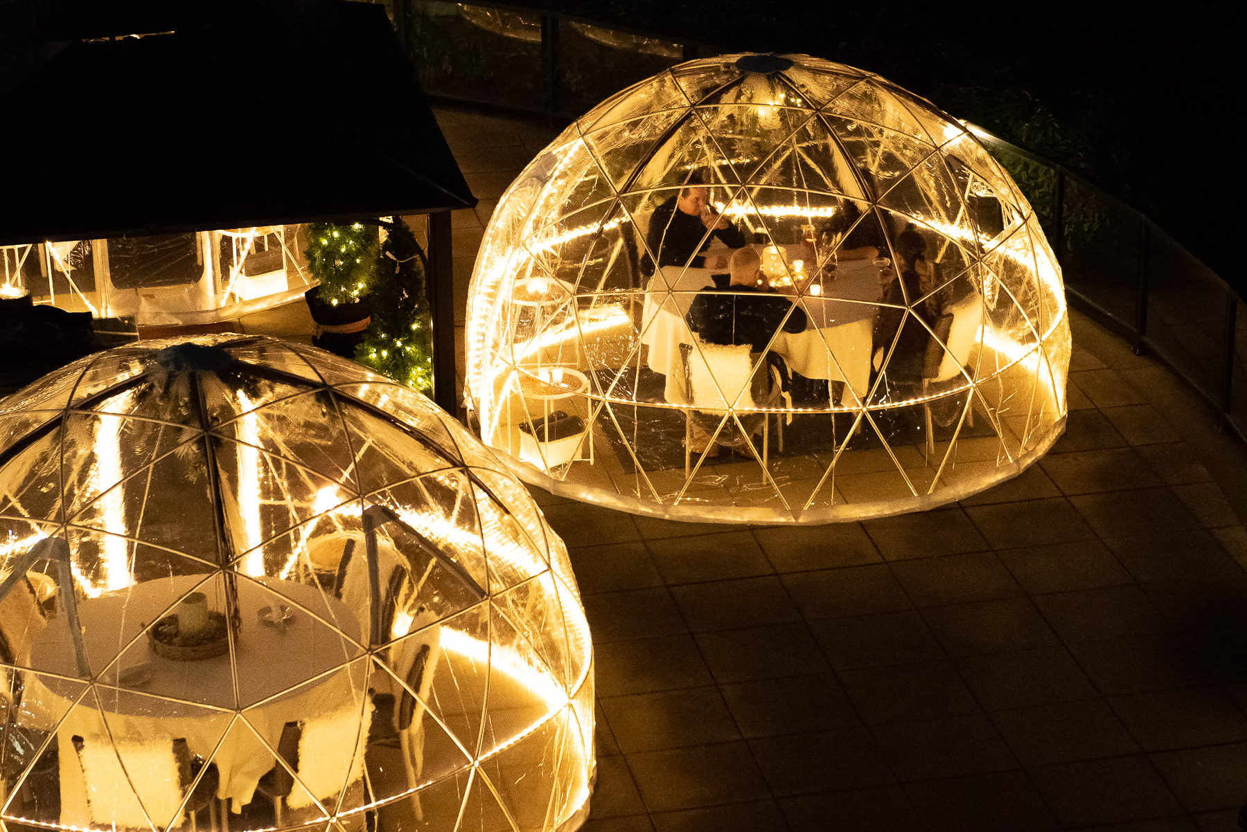 a group of people sitting at tables inside a dome